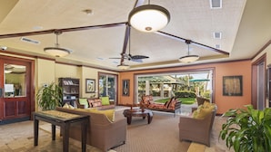 A spacious lobby with a high ceiling, a ceiling fan, and a large window offering a view of the outdoor garden. - Big Island Waiulaula at Mauna Kea by Coldwell Banker Island Vacations (Kamuela)