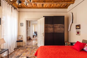 A bedroom with a bed, a wardrobe, a chair, a table, and a lamp. - Rustic Villa Okra With Pool (Opatija)