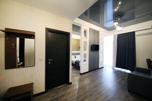 Luxury Double Room | Living area | Flat-screen TV, printers