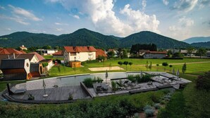 A residential area with houses, a swimming pool, and a wooden deck. - Honeycomb Chalets and Apartments Mozirje (Mozirje)