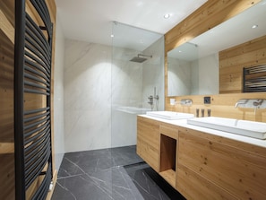 Bathtub, slippers, towels, soap