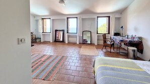 A spacious room with a ceiling fan, large windows, a bed, a table with a tablecloth, and a chair. - VILLA CAMELIA- 5 bedrooms, sea view, swimming pool (ALBITRECCIA)