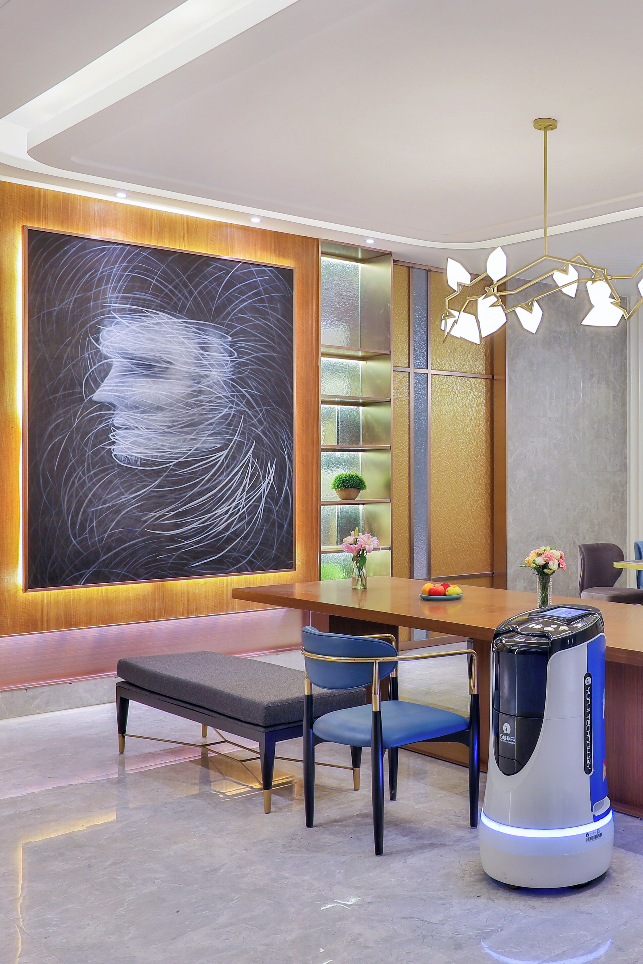 A modern interior with a large abstract artwork, a dining area with a bench and chairs, a coffee machine, and a staircase with a plant.