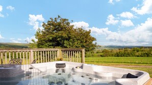 A hot tub with a wooden deck and a view of a green landscape. - The Buchanan - sleeps 6 guests  in 3 bedrooms with hot tub - 5 star award winning lodges (Lauder)