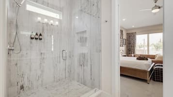 Bathtub, hair dryer, towels, shampoo