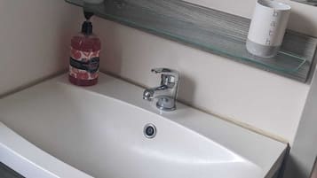 Shower, hair dryer, towels, toilet paper
