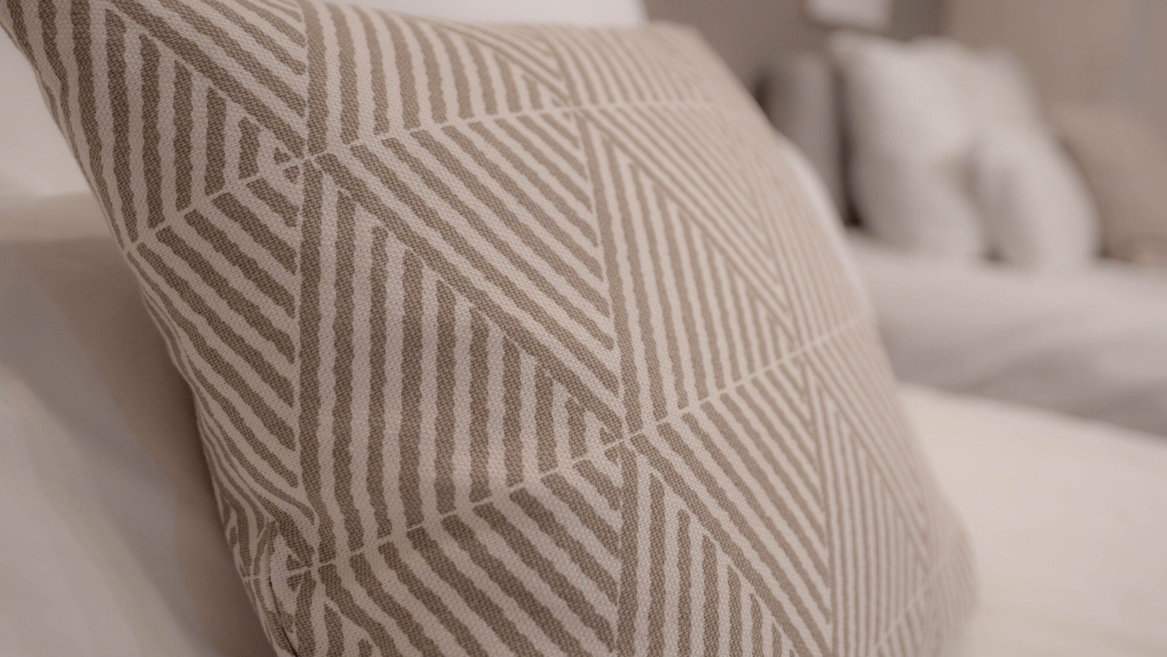 A close-up of a pillow with a geometric pattern.