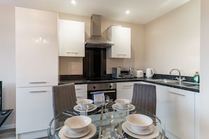 Enjoy cooking in this well-equipped kitchen with an oven, microwave, and range hood.