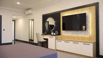A modern bedroom with a bed, a desk, a chair, a large mirror, and a TV mounted on the wall.