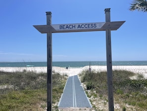 Access the beach via this pathway, marked by a signpost at the entrance.
