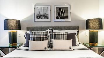 A neatly arranged bedroom with a bed, two side tables, and two lamps.