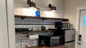 A compact kitchen with a microwave, coffee maker, and a dishwasher. - Refined Studio, New Construction, 1 Mile From Town (Pittsburgh)
