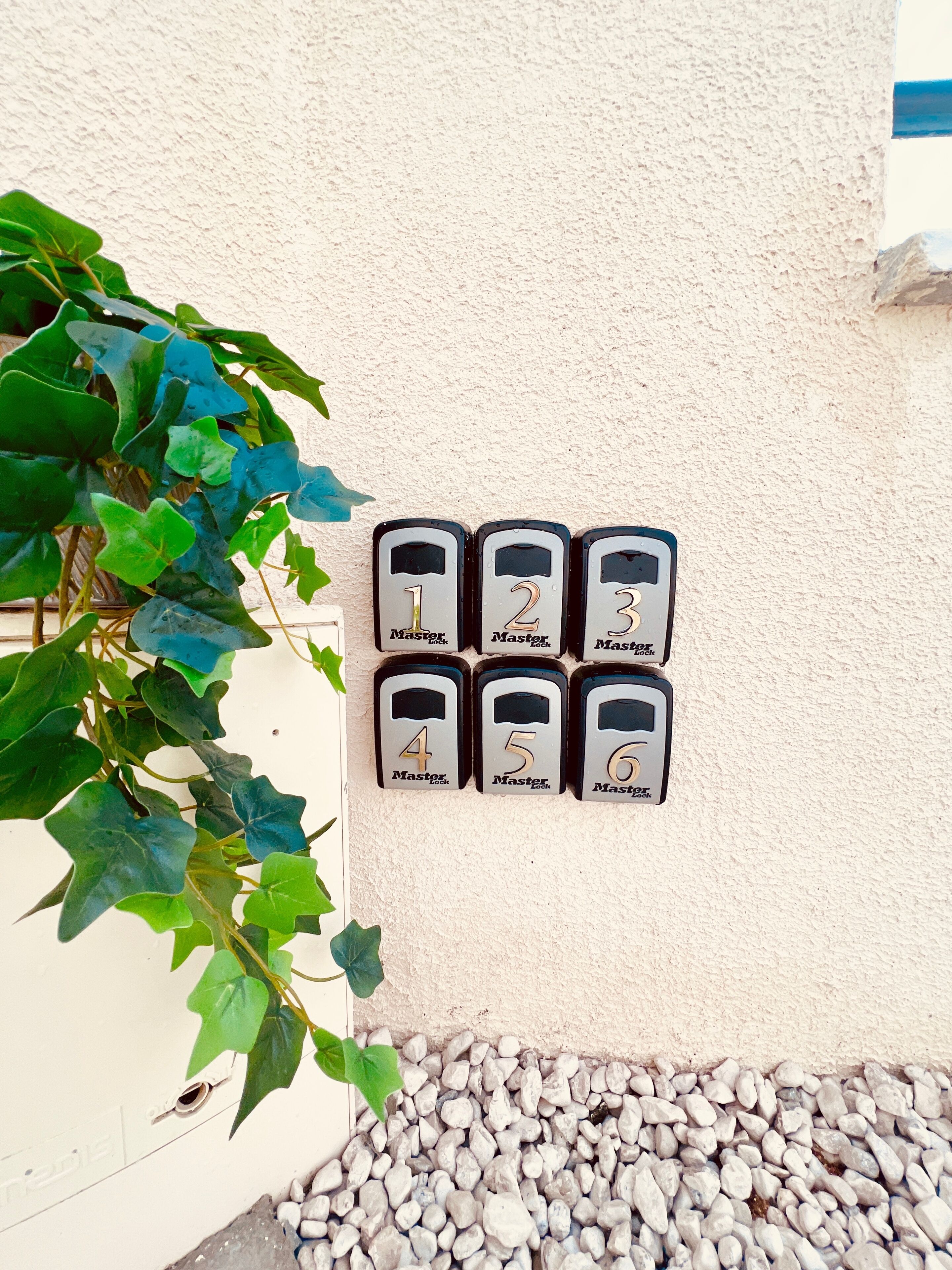A wall-mounted keypad with numbered locks from 1 to 6, likely for a residential building.