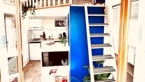 A modern interior with a kitchen, dining area, and a staircase. - De la Terre à la Lune (Amiens)