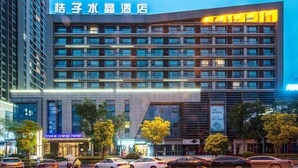 A multi-story hotel with a modern facade, large windows, and a prominent entrance.
