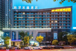 A multi-story hotel with a modern facade, large windows, and a prominent signage for the Crystal Orange Hotel. - Crystal Orange Hotel Changzhou Dinosaurs Park (Changzhou)