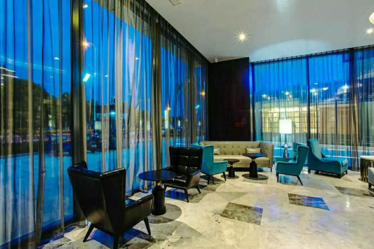 A modern lounge area with a sofa, chairs, and a coffee table.