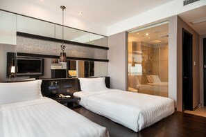 A hotel room with two beds, a TV, a control panel, and a glass shower area. - Crystal Orange Hotel Changzhou Dinosaurs Park (Changzhou)