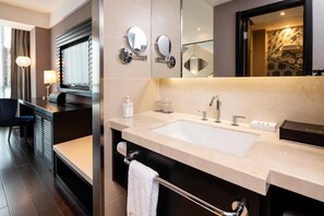 A modern bathroom with a large sink, two mirrors, a towel rack, and a toilet. - Crystal Orange Hotel Changzhou Dinosaurs Park (Changzhou)