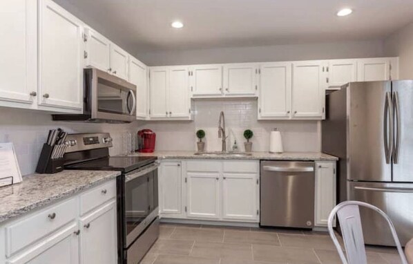 Enjoy cooking in this well-equipped kitchen with stainless steel appliances and granite countertops.