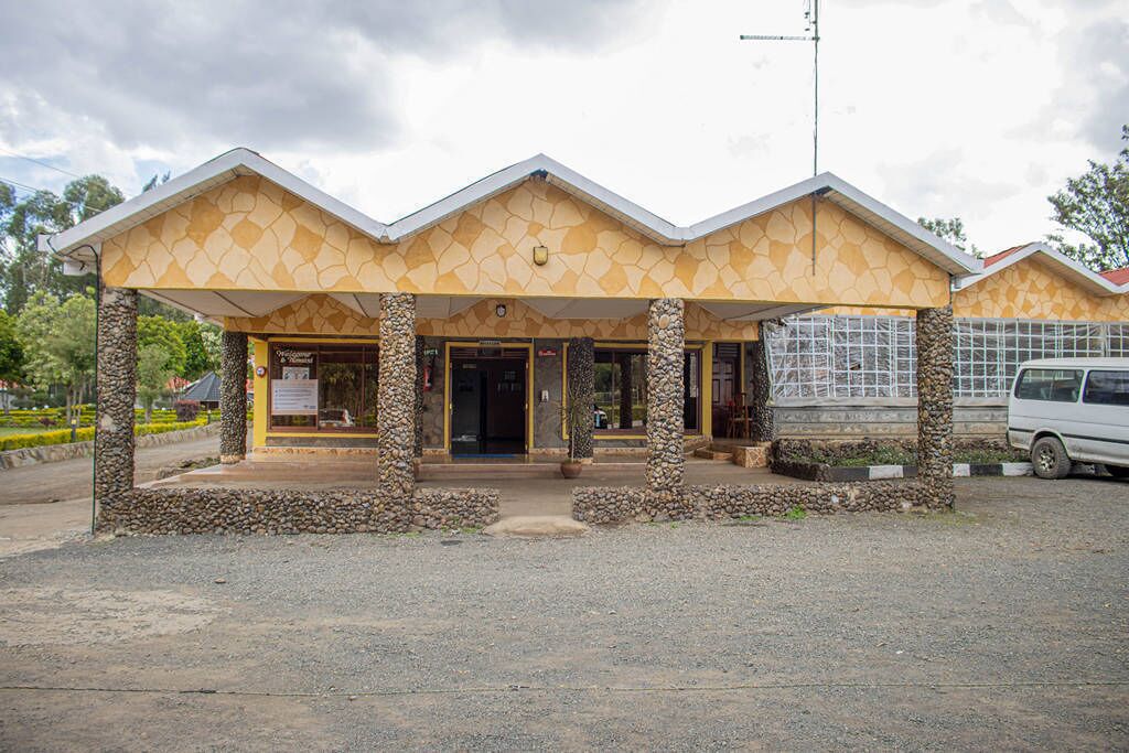 A building with a stone facade and a covered entrance area.