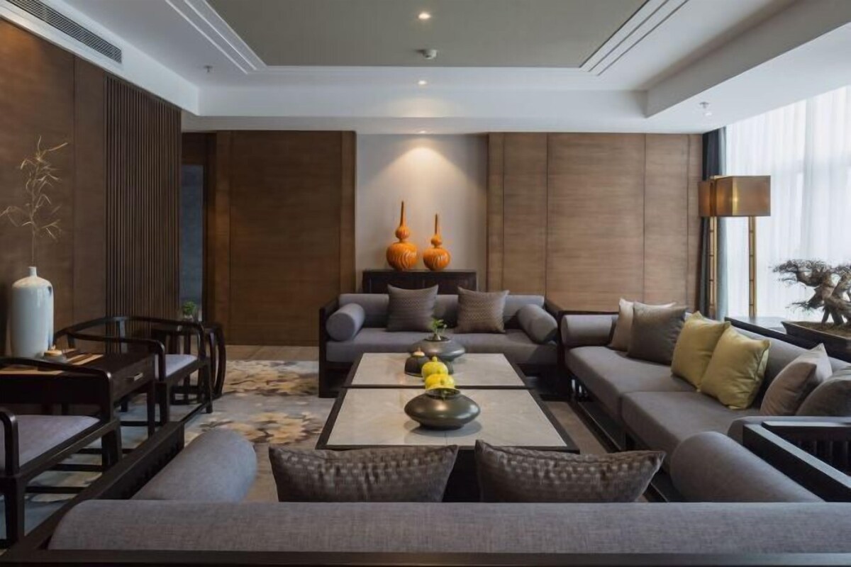 A modern living room with a sofa, coffee table, and decorative vases.