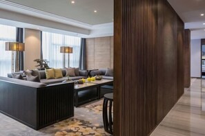 A modern living room with a sofa set, a coffee table, and a decorative plant. - OffCN HY Hotel (Nanjing)