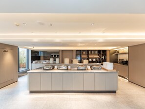 A modern kitchen with a central island, built-in appliances, and ample storage space. - JI Hotel Nanning Dongge Road (Nanning)
