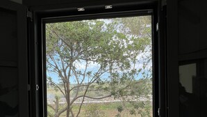 A window with a view of a tree and a gravel path. - Countryside farm family house, private, calm with mountain views (Sangri)