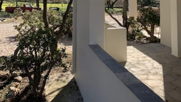A covered outdoor area with a stone floor, surrounded by trees and a clear sky. - Countryside farm family house, private, calm with mountain views (Sangri)