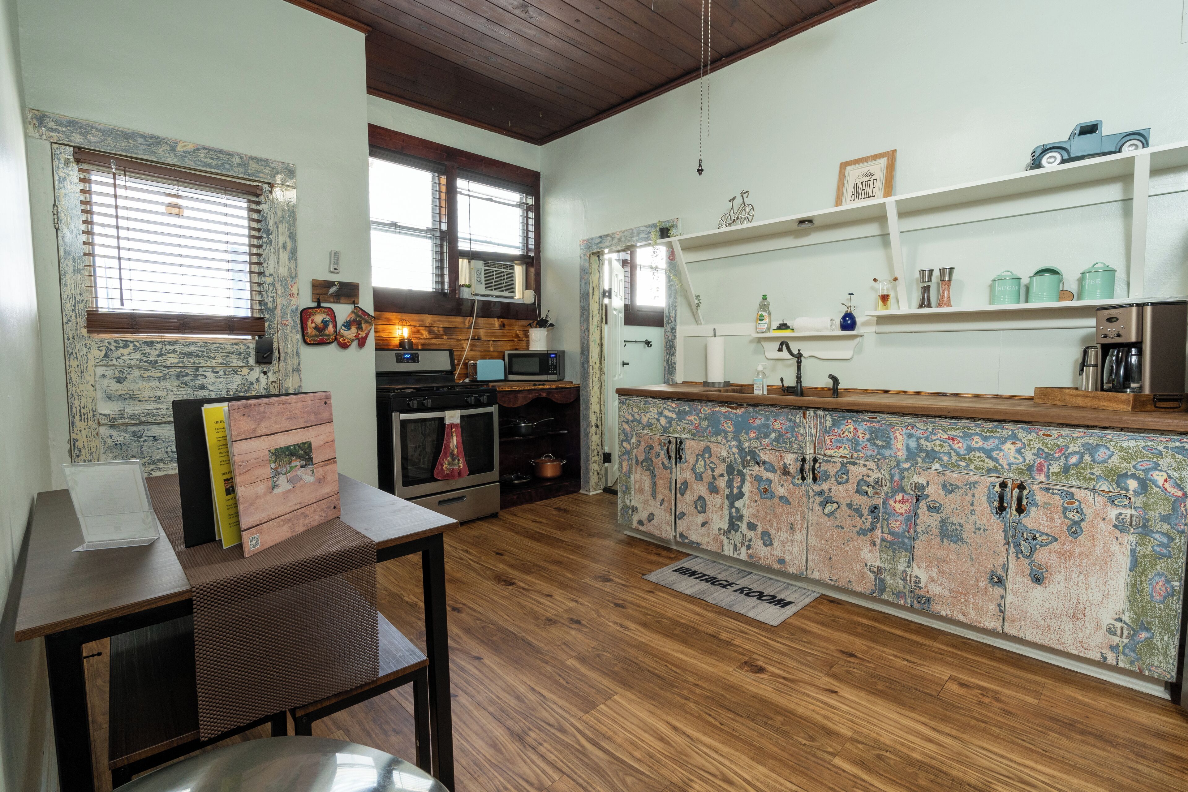 A kitchen with wooden cabinets, a microwave, and a coffee maker.