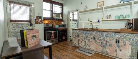 A kitchen with wooden cabinets, a microwave, and a coffee maker.