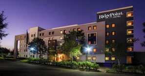 A multi-story hotel with a modern design, featuring a prominent sign for RidgePoint Hotel.