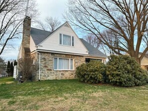 Stunning two-story house with a charming front entrance and inviting porch.
