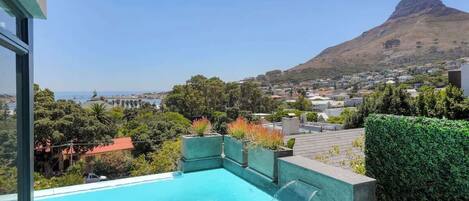 An infinity pool, pool loungers