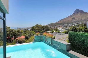 An infinity pool, sun loungers