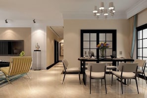 A modern dining area with a table set for four, surrounded by chairs, a vase with flowers, and a large window with blinds. - Huayuan Homestay (Huangshang Scenic Area South Gate) (Huangshan City)