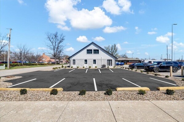 A building with a parking lot in front.