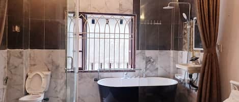 Luxury Studio | Bathroom | Deep soaking tub, hydromassage showerhead, hair dryer, slippers