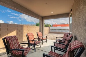 Relax in style on this outdoor patio with comfortable seating and a scenic view.