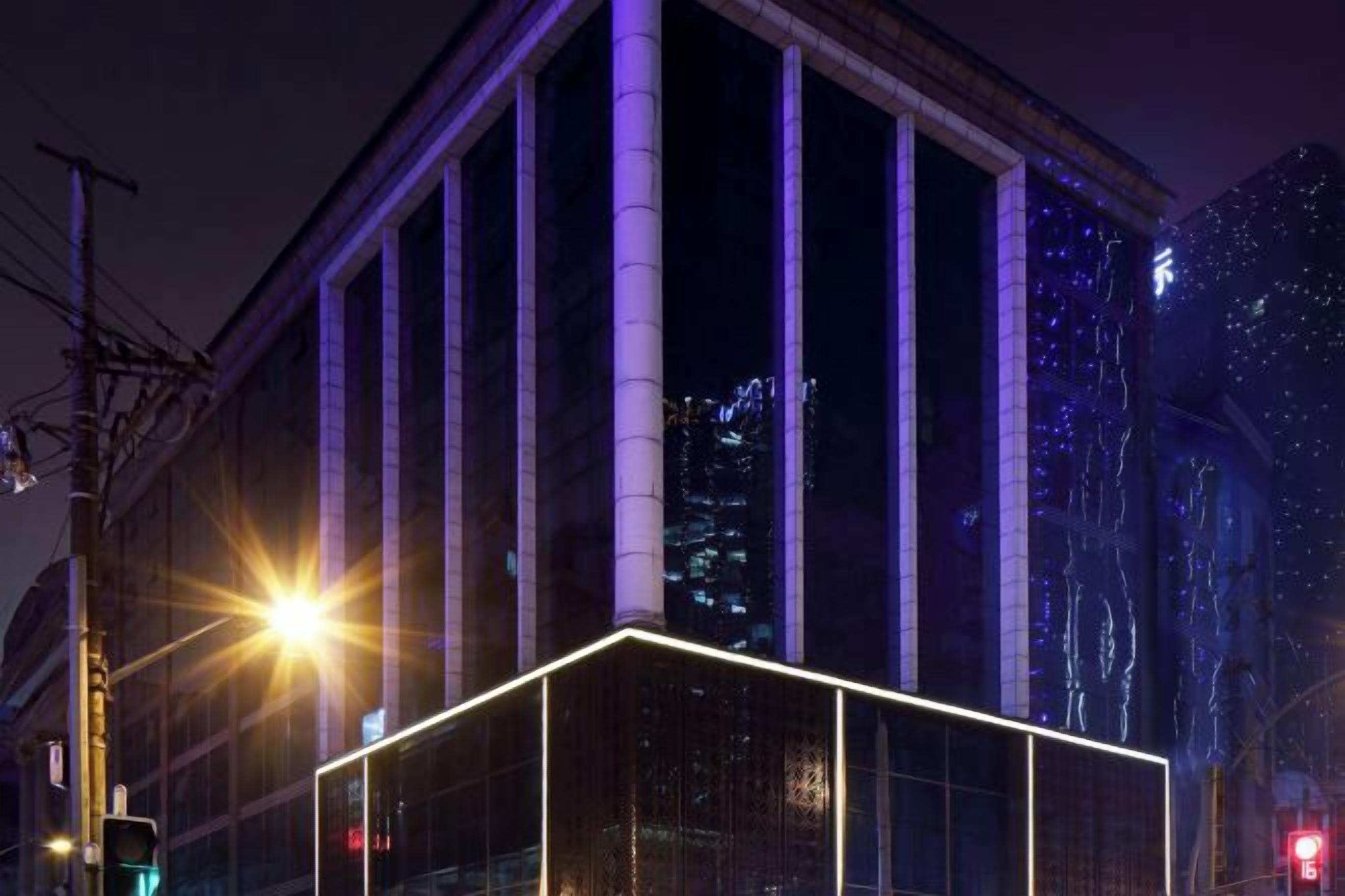 A modern building with large windows and a glass facade, likely a hotel or office building.