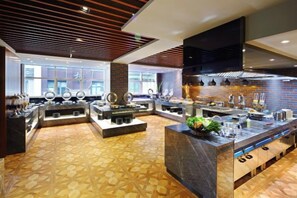 A modern kitchen with a central island, built-in appliances, and a patterned floor. - Zhenyue Hotel (Shanghai)