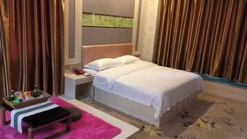 A bedroom with a bed, bedside table, and a small bench.