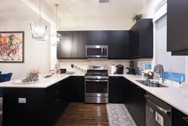 Enjoy cooking in this well-equipped kitchen with a microwave, oven, and sink.