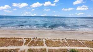 Una playa con cielo despejado y mar tranquilo.