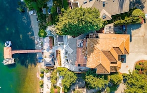 An aerial view of a residential area with houses, a dock, and a small boat.