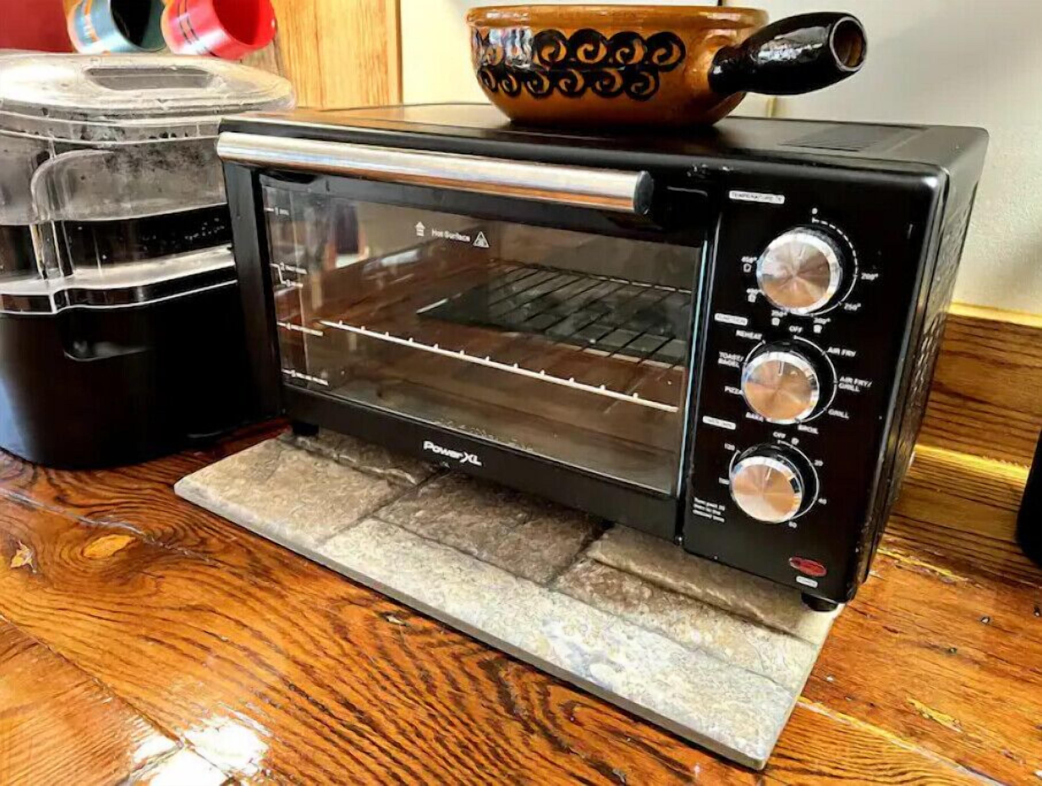 A toaster oven with a digital display and multiple control knobs.