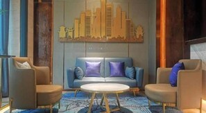 A modern living room with a sofa, two armchairs, and a coffee table. - Yitel Collection (Chengdu DuFU Thatched Cottage & Sichuan Provincial People's Hospital Station） (Chengdu)