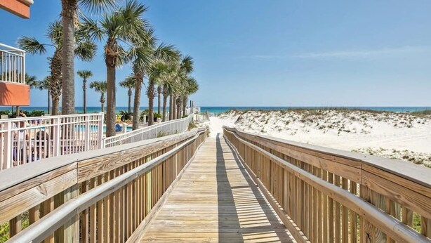 A wooden boardwalk leading to a beach with palm trees and a clear sky. - Beach Bella-Sleeps 8, 3 min Walk to Beach (Destin)