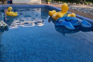 A swimming pool with inflatable toys. - Wutong Shouwang Hostel (Deqing)